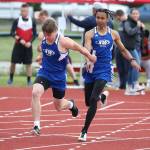 Issiah Gonzales hands the baton to Bodie Hezel in the 4x100 relay.(Photo by John Fisken)