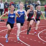 South Whidbeys Alexandra Kurtz receives the baton from Mattason Straub in a relay heat Thursday. (Photo by John Fisken)