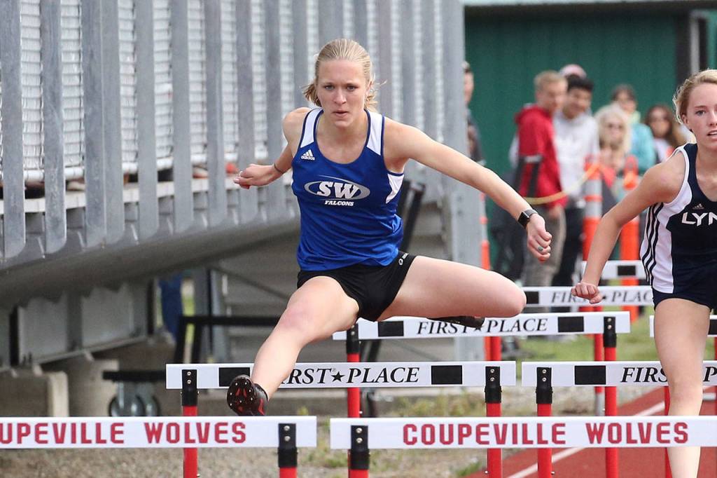 Camille Young glides over a barrier in the 100 hurdles.(Photo by John Fisken)