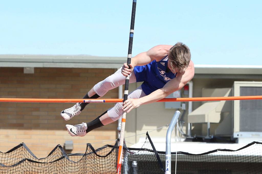 Billy Rankins clears the bar in the pole vault,(Photo by John Fisken)