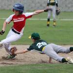 South Whidbey shortstop Jaden Adragna (29)  donning traditional high-stirrup socks  dives in an attempt to tag a Central Whidbey base runner Wednesday. (Photo by Jim Waller/South Whidbey Record)