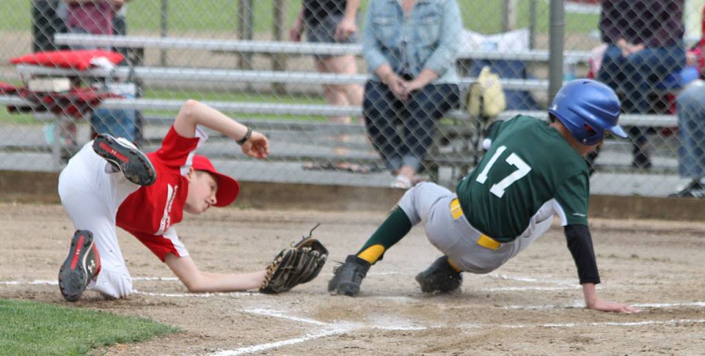 Malachi Pierson (17) slides by the tag to score a run for the South Whidbey Athletics.(Photo by Jim Waller/South Whidbey Record)