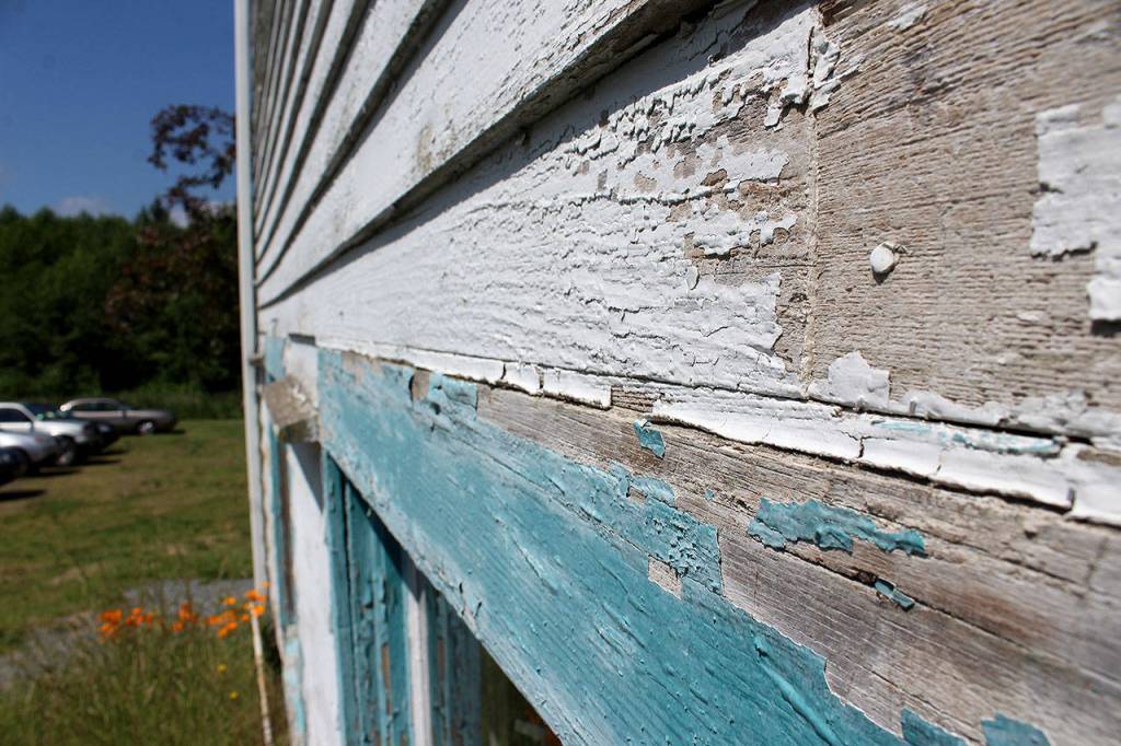 Bare spots of chipped off paint reveal the wood and construction of Bayview Community Hall, built in 1927.