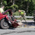 Photo by Laura Guido/Whidbey News-Times                                North Whidbey Fire/EMS Firefighter Ian Eby cleans up the scene of a head-on traffic accident Wednesday afternoon. Three people were sent to the hospital with non-life-threatening injuries. Highway 20 just south of Oak Harbor was closed for about an hour.