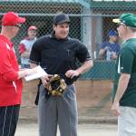 Umpire Jim Honold, center, goes over the ground rules with Central Whidbey coach Jon Roberts, left, and South Whidbey Athletics coach Steve Zarifis. (Photo by Jim Waller/South Whidbey Record)