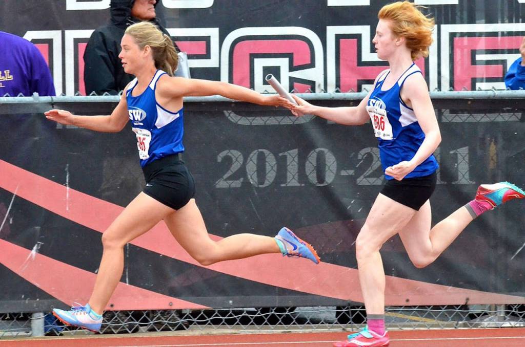 Mattason Straub, right, hands the baton to Mallory Drye.(Photo by Karen Swegler)