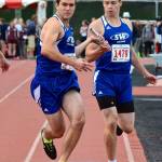 Max Dodd takes the baton from Bodie Hezel in the 4x400 relay.(Photo by Karen Swegler)