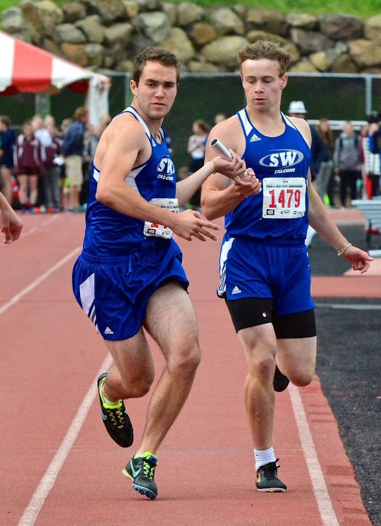 Max Dodd takes the baton from Bodie Hezel in the 4x400 relay.(Photo by Karen Swegler)