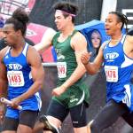 Matthew Simmons, left, takes off after receiving the baton from Issiah Gonzales.(Photo by Karen Swegler)