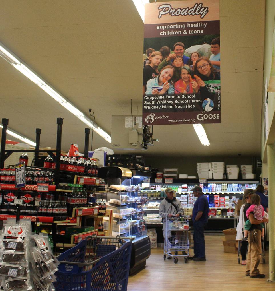 Banners explaining the connection between The Goose Grocer and Goosefoot line the back aisle of the super market.