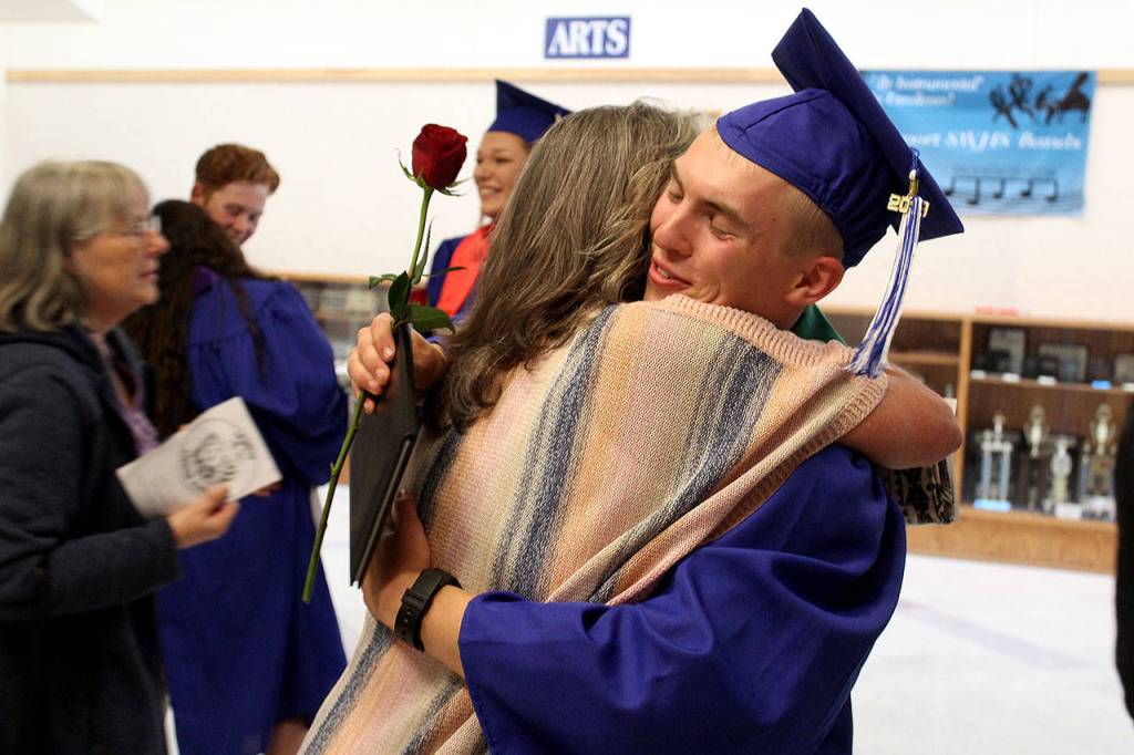 South Whidbey Academy graduate Andrew Tangeman receives a big hug after Fridays ceremony celebrating the graduation of 13 students in the alternative program. Photo by Patricia Guthrie/Whidbey News Group