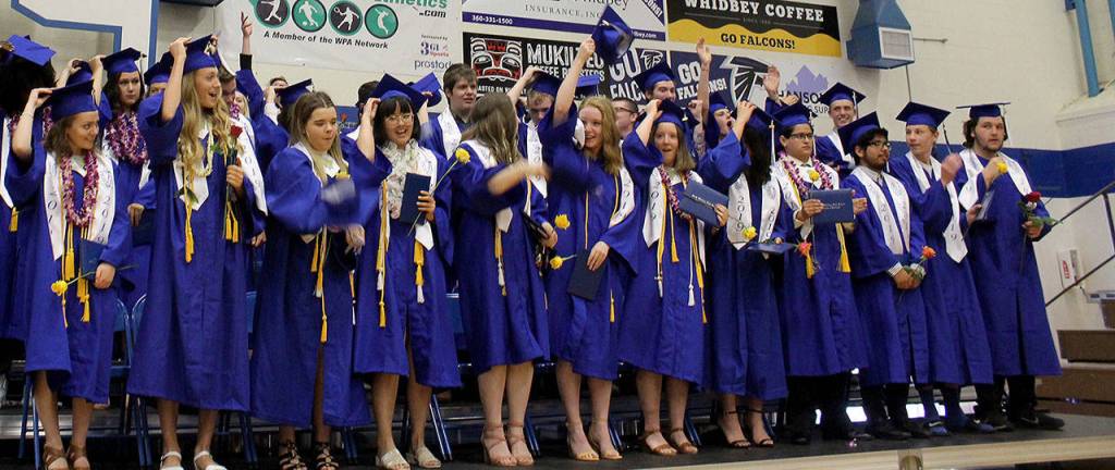 South Whidbey High graduates move their cap tassle from the right to the left after receiving their diplomas at Saturdays commencement in the school gymnasium. Photo by Patricia Guthrie/Whidbey News Group