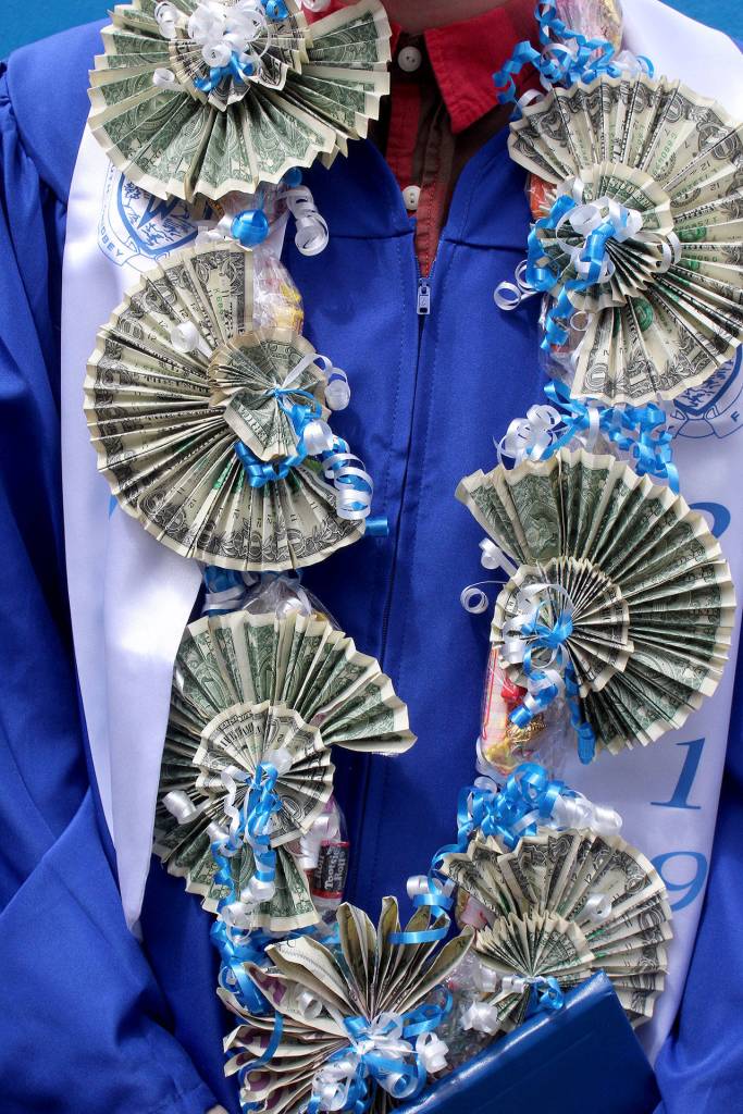 Elijah Thomas Waldron decked himself out in dollars with his cap and gown for Saturdays South Whidbey High School 2019 commencement. Photo by Patricia Guthrie/Whidbey News Group