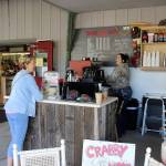 Customer Kerry Harper tells barista Maddy Triplett she was pleasantly surprised to find a new Crabby Coffee opened outside the Island Senior Resources Thrift Store. Photo by Patricia Guthrie/Whidbey News Group