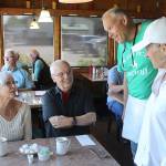 Freeland Cafe new owners Jeff and Deb Kennelly talk to customers during a busy Fathers Day Sunday breakfast. Photo by Patricia Guthrie/Whidbey News Group