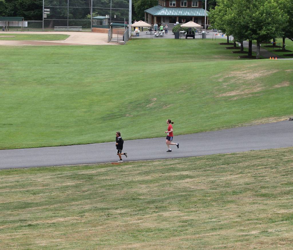 A pair of runners complete the first lap.(Photo by Jim Waller/South Whidbey Record)