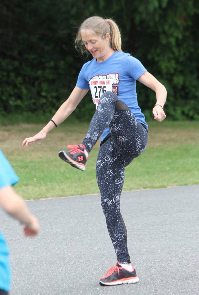 Samantha Shaw leads the runners in a warm-up routine prior to the race. (Photo by Jim Waller/South Whidbey Record)
