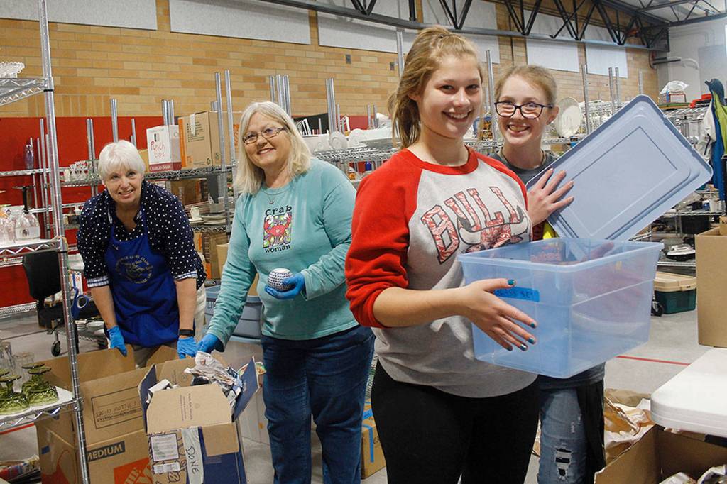 From left to right: Volunteers Linda Youngs, Susan Haworth, Ivy Leedy and MacKenzie Davis sort through donated items. Youngs and Haworth are Lions members and Leedy and Davis are members of the Coupeville Softball team.                                (Photo by Maria Matson/Whidbey News Group)