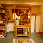 In the kitchen, the doors of the refrigerator open to reveal fully-stocked shelves.