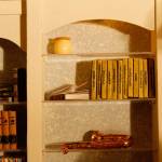 The music room bookshelf contains small books with titles such as Dracula, White Fang and Phantom of the Opera.