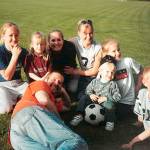 The Newmans take a break from the action in 2002. Mike lies in front surrounded by his children, Lindsey (left), Carlie, Jenny, Caitie, Kody (with soccer ball), Haley and Riley. (Provided photo)