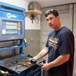 Joe Hilton, a welding instructor for the apprenticeship program, shows the machine that combines virtual reality with reality to teach welding skills.