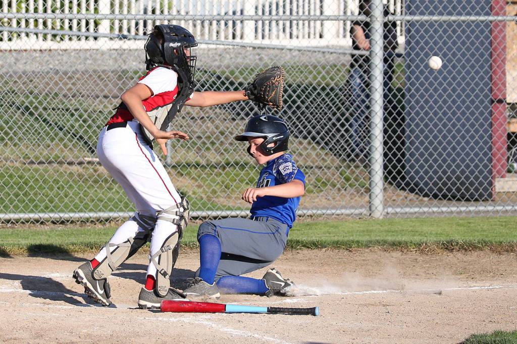Connor Bartel slides safely into home for a Central Whidbey run.(Photo by John Fisken)