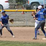 Second baseman Alexander Zarifis flips to shortstop Jaden Adragna Saturday.(Photo by Jim Waller/South Whidbey Record)