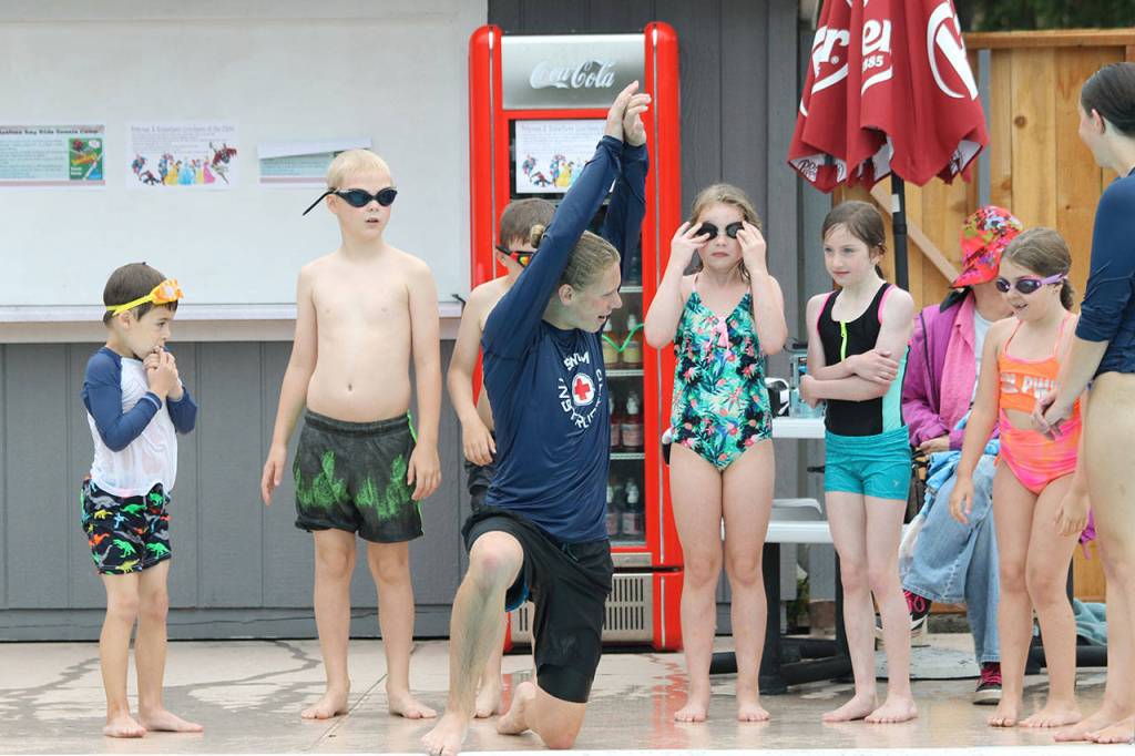Sam Baesler explains diving technique to a group of students.(Photo by Jim Waller/South Whidbey Record)