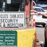 A passenger pays a toll at the Mukilteo ferry dock tool booth on Tuesday. (Andy Bronson / The Herald )