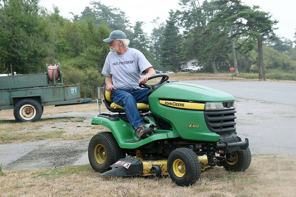 Gary Formhals backs up a mower at Fort Casey State Park. He is one two volunteers at the park to be recognized by State Parks.