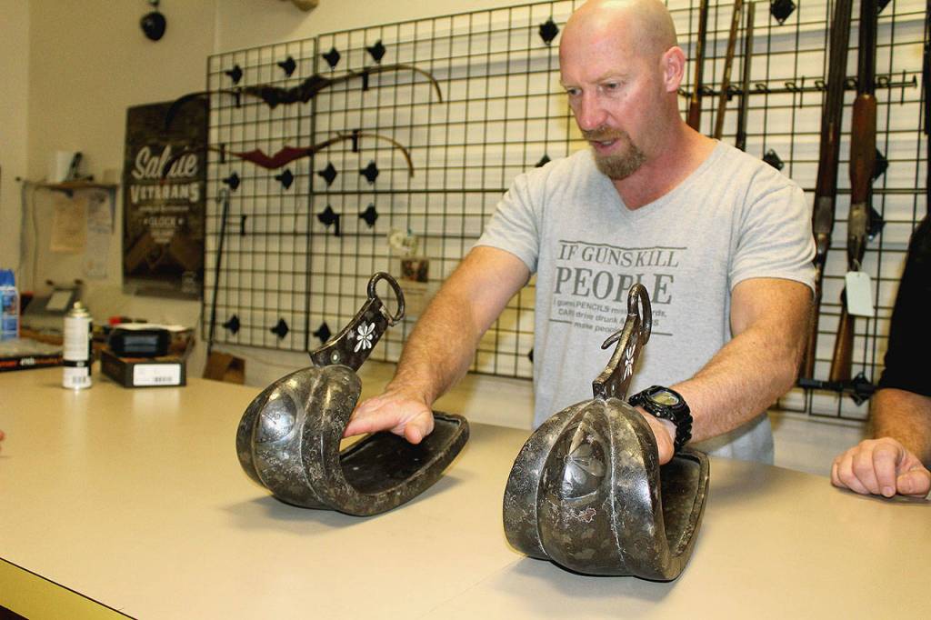Military veteran Sherman Smitty Smith examines Japanese samurai warrior stirrups dating back centuries. Photo by Wendy Leigh/South Whidbey Record