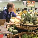 Employee Seth Haynie stocks organic produce at The Goose Community Grocer in Bayview. Photo by Wendy Leigh/South Whidbey Record