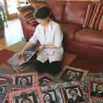 Fiber artist Cheryl Lawrence spreads out a selection of her 131 katazome textile art portraits of the women currently serving the 116th U.S. Congress
