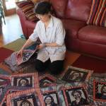 Fiber artist Cheryl Lawrence spreads out a selection of her 131 katazome textile art portraits of the women currently serving the 116th U.S. Congress