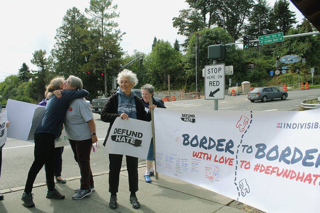 The Border to Border with Love banner arrives into Clinton on Sept. 8 as part of a march from Blaine, Wash. to San Diego, Calif. Photo by Wendy Leigh/South Whidbey Record