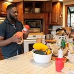 Shaquille Walker, youth advocate at Ryans House for Youth, helps clean the kitchen at the drop-in center.