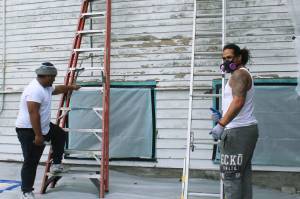 Workers Mason Tau, right, and Barry Brown, left, begin restoration project at Bayview Community Hall in Sept. 2019 after community meets its fundraising goal. Photo by Wendy Leigh/South Whidbey Record