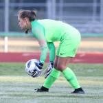 Nicole Helseth scoops up the ball for South Whidbey.(Photo by John Fisken)