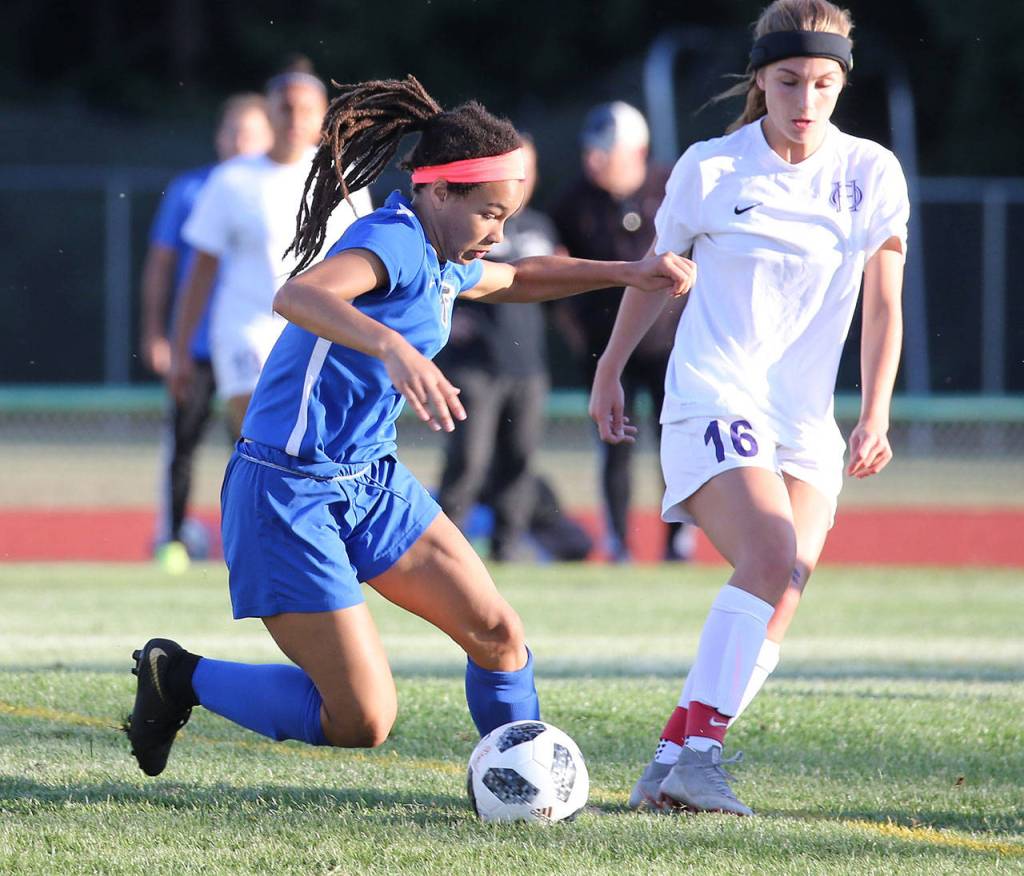 Simone White controls the ball for the Falcons. The South Whidbey freshman scored two goals in her first varsity match.(Photo by John Fisken)