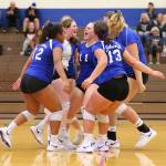 Falcons Maya Tschetter (12), Kayla Knauer (9), Emma Hodson (11), Grace Halsted (13) and Morgan Batchelor celebrate a point in Tuesdays match. (Photo by John Fisken)