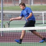 Ranger Buck hits a forehand while winning first doubles.(Photo by John Fisken)