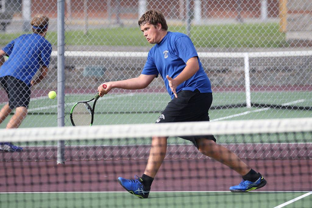 Ranger Buck hits a forehand while winning first doubles.(Photo by John Fisken)