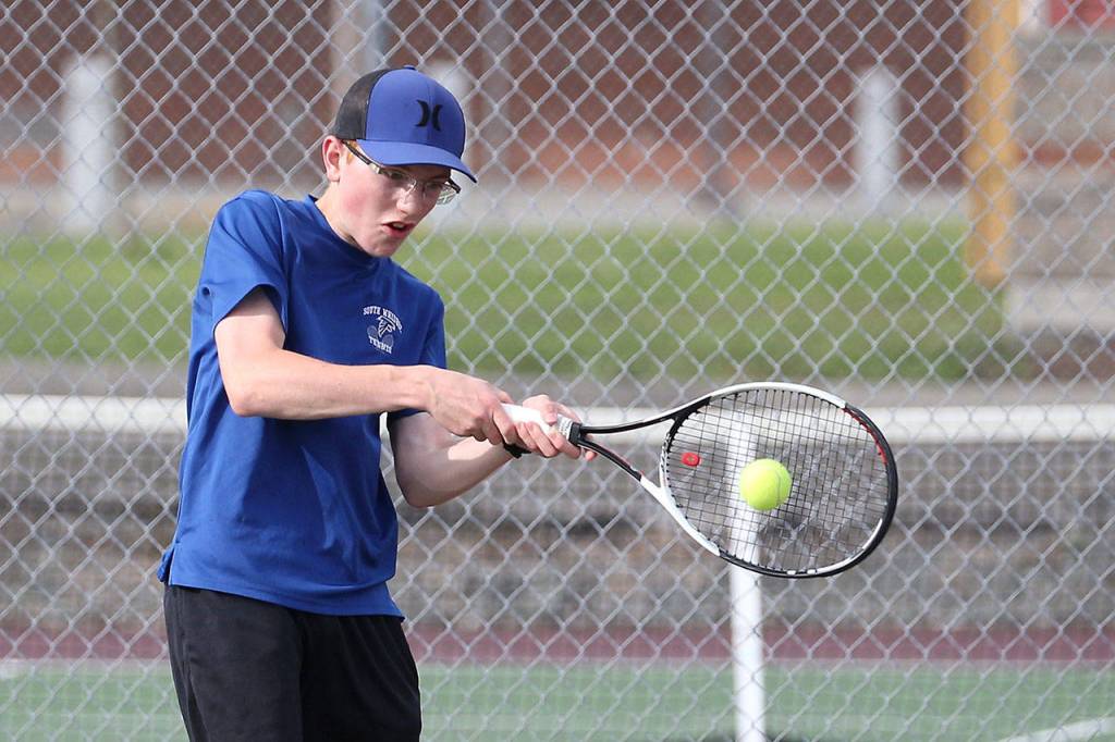 Max Rodriguez drives the ball in first singles action.(Photo by John Fisken)