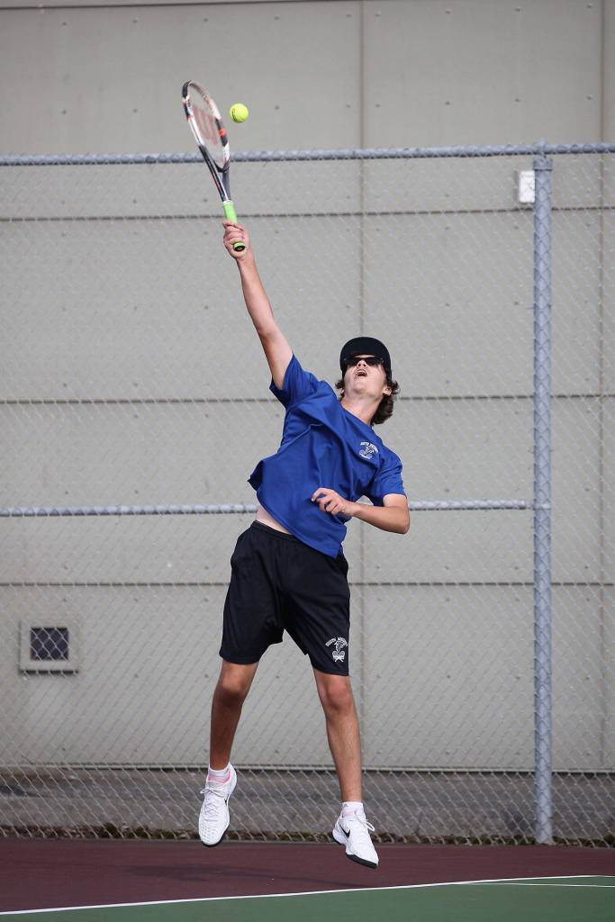 Ben Roughsedge fires a serve in second doubles.(Photo by John Fisken)