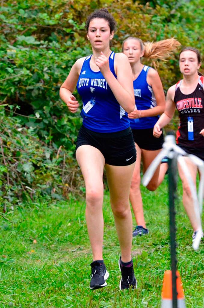 Flannery Friedman, left, and Laila Gmerek run with Coupevilles Alana Mihill.(Photo by Matt Simms)