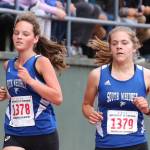 South Whidbeys Jasmin Graner, left, and Grace Huffman run together toward the finish line at the Sehome Invitational. (Photo by John Fisken)