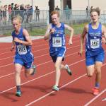 Thomas Simms, left, Reilly McVay and Cooper Ullman head down the home stretch together. (Photo by Jim Waller/South Whidbey Record)
