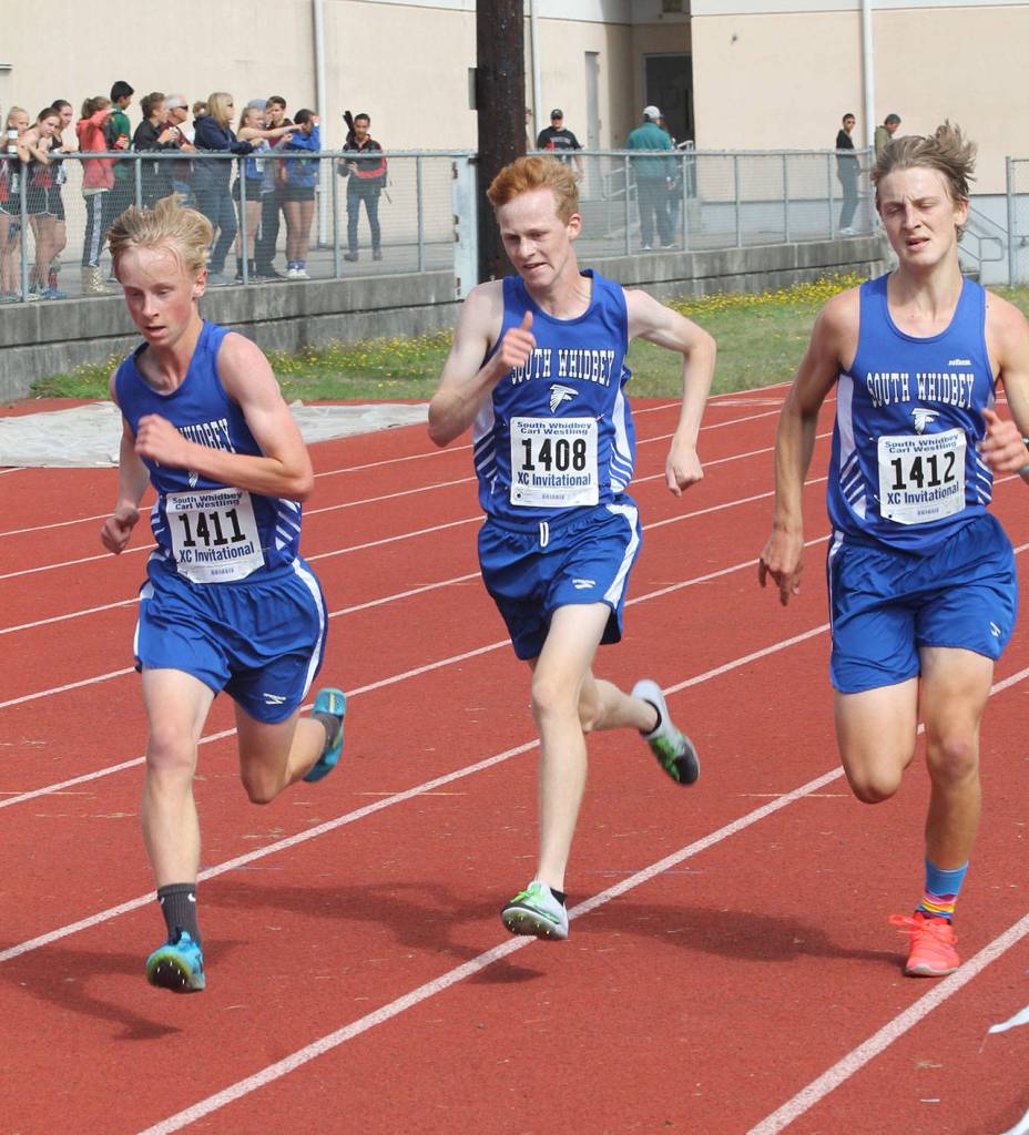 Thomas Simms, left, Reilly McVay and Cooper Ullman head down the home stretch together. (Photo by Jim Waller/South Whidbey Record)