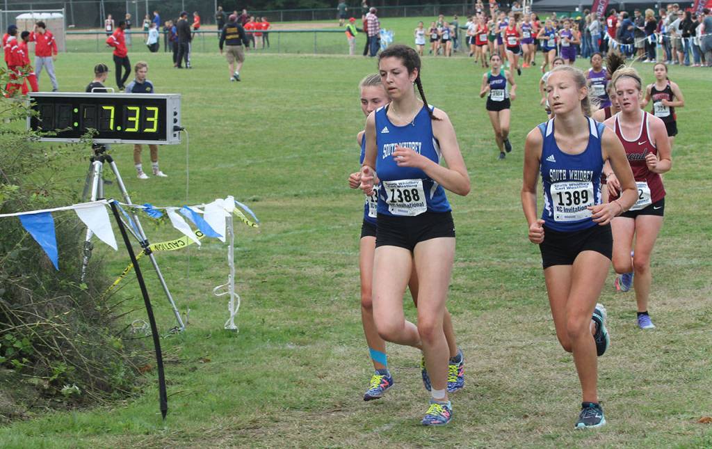Natalie Rodriguez, left, Flannery Friedman and Laila Gmerek begin the second loop of the course.(Photo by Jim Waller/South Whidbey Record)